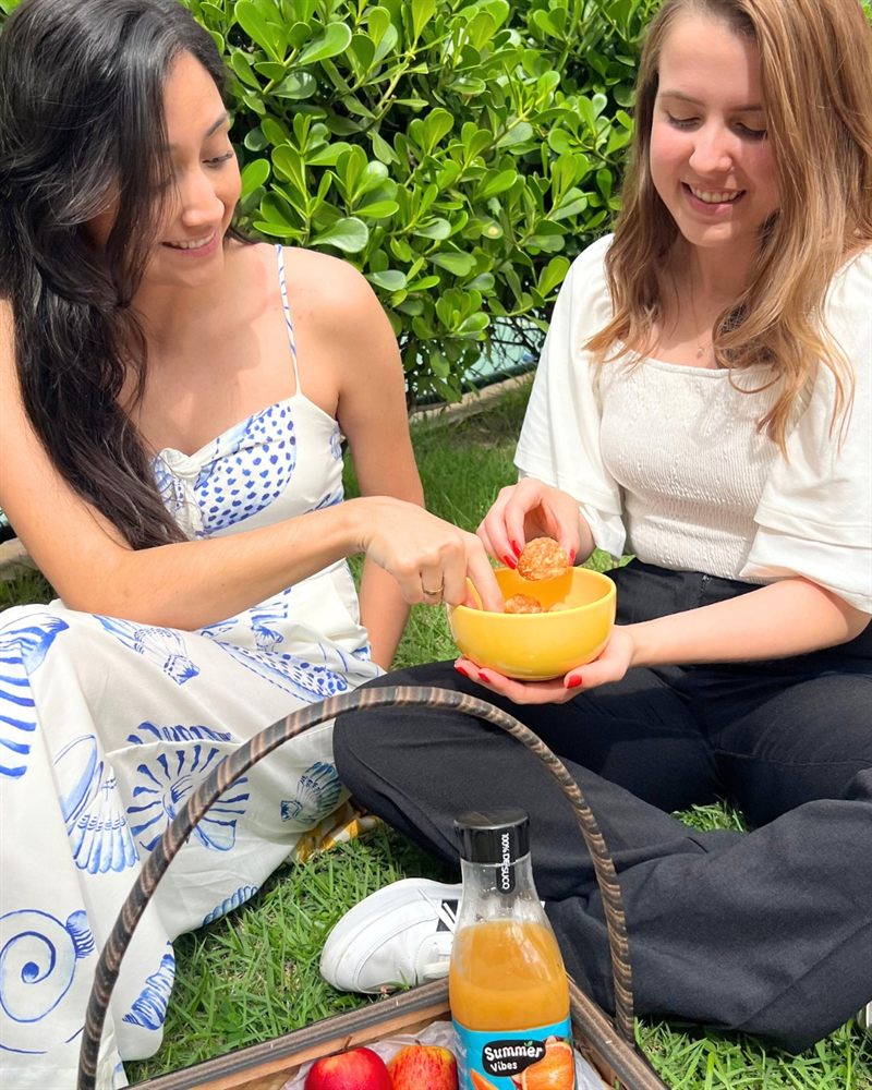 Friends sharing Queijoca at a picnic